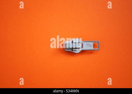 zipper on the orange background Stock Photo
