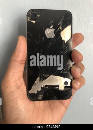Man holding broken iPhone, in need of repair Stock Photo