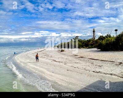 Lone man walking along beach in Sanibel Florida Stock Photo