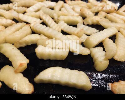 Oven chips on a baking tray Stock Photo