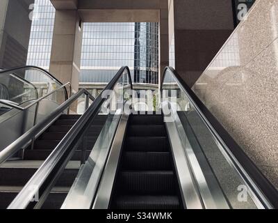 LOS ANGELES, CA, MAR 2020: escalators leading to base of office building, skyscraper at California Plaza in Downtown Stock Photo