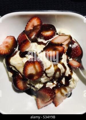 Desert, vanilla ice cream, fresh strawberries, fruit, healthy fruit, sliced, drizzled, chocolate syrup, food, served on white plate, closeup, Stock Photo
