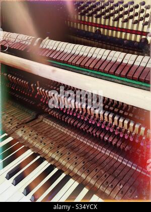 Inside workings of an upright piano, with colour effects Stock Photo