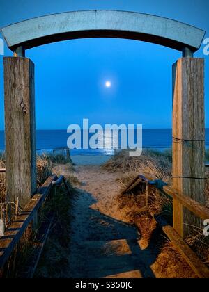 The moon rises over the sea at North Beach in Mablethorpe, Lincolnshire Stock Photo