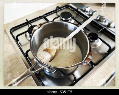 https://l450v.alamy.com/450v/s351t5/a-close-up-view-of-porridge-oats-cooking-on-a-gas-stove-simmering-rolled-oats-and-milk-in-a-silver-pan-with-milk-healthy-breakfast-with-wooden-spoon-s351t5.jpg