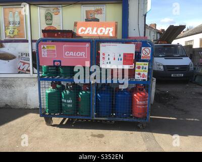 Cylinders of Calor Gas on a rack outside a shop in Bristol, UK Stock Photo