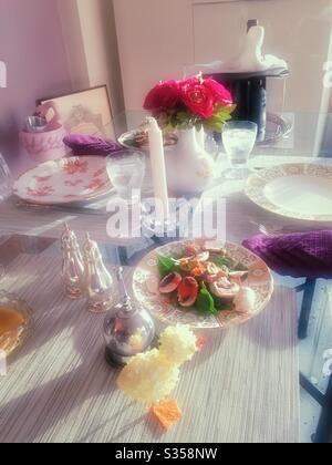 Table A festive Easter dinner table features China, silver and decorative duckling and bunny, USA Stock Photo