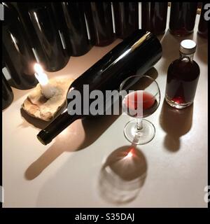 Bottling a Syrah rosé d'assiette wine in large format [magnum] bottles by candlelight, Catalonia, Spain. Stock Photo