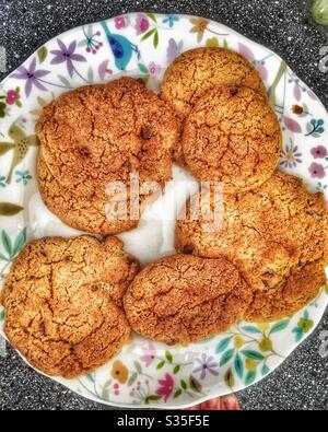 Homemade chocolate chip cookies on a portmerion plate Stock Photo