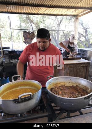 Two chefs working in an outdoor kitchen. Stock Photo