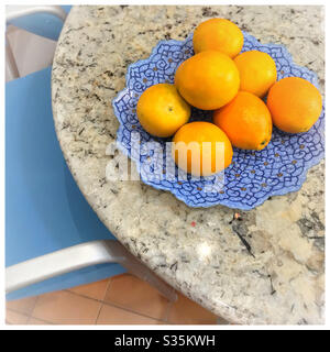 Oranges on kitchen table. Stock Photo