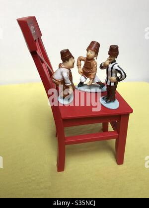 Chocolate Figurines Playing on a Chair Stock Photo