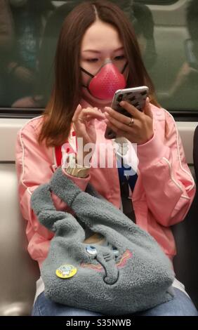 A woman from Hong Kong wearing a stylish mask during the covid 19 pandemic. Stock Photo