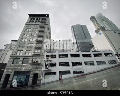 LOS ANGELES, CA, APR 2020: Metro 417 apartment building, formerly railway terminal, and parking structure at the corner of 4th St and Hill St in Downtown. Skyscrapers in background Stock Photo