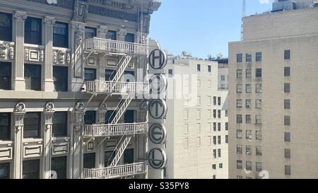 LOS ANGELES, CA, APR 2020: corner of Hotel Clark with exterior fire escape, and nearby apartment and office buildings, Downtown Stock Photo