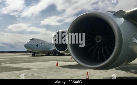 Cathay Pacific Boeing 747-800 freighter Taxying in, in Anchorage Alaska past another one already parked. Stock Photo