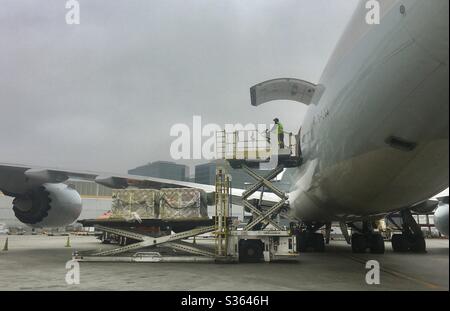 Loading a Cathay Pacific Airways Boeing 747-800 freighter in Los Angeles, California. Stock Photo