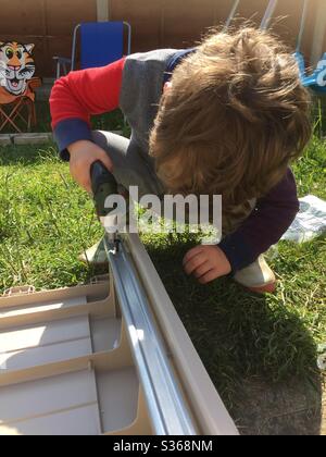 Toddler doing diy Stock Photo