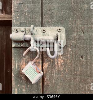 Open padlock on a garden gate latch Stock Photo