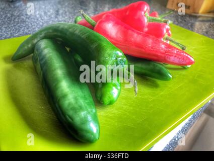 Green Chopping Board With Red and Green Chillis on it Stock Photo