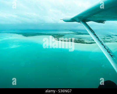 The view from the copilot’s seat of the reefs and Caribbean Sea between Belize City and the island of Ambergris Caye, Belize on March 8, 2020. Stock Photo