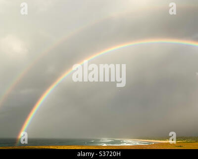 Double rainbow over the ocean and beach Stock Photo