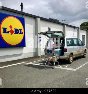 Loading shopping into car outside LIDL store, France. Stock Photo