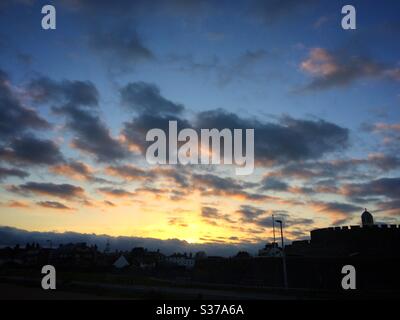 Sunset over Deal castle with the town in silhouette, Kent, UK Stock Photo