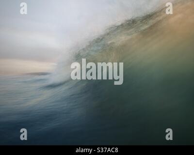 A slow exposure of a wave breaking. Stock Photo