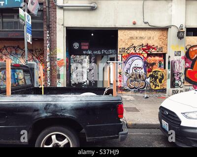 Cars parked on a street next to murals and graffiti in CHAZ CHOP autonomous zone on Capitol Hill in Seattle, June 2020 Stock Photo