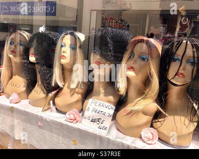 Window display of women’s wigs - France. Stock Photo