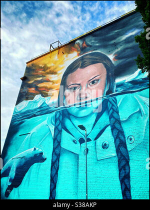 A wall mural of the Swedish Activist - Greta Thunberg - is painted on the side of a tall building in Bristol, England. Global warming means rising ocean levels. Photo ©️ COLIN HOSKINS. Stock Photo