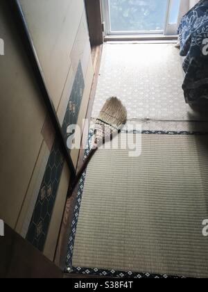 Old straw broom by the tatami floor of traditional Japanese house Stock Photo