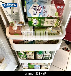 Refrigerator door filled with cartons of healthy plant-based alternative milks in preparation for Covid virus lockdown and shops running out of supplies. Stock Photo