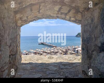 View through city wall towards budva beach Stock Photo