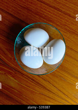 Three eggs in a glass dish Stock Photo