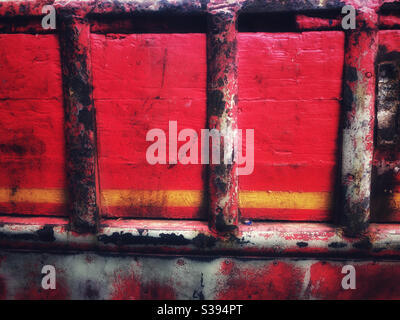 The side of an old trawler painted red Stock Photo