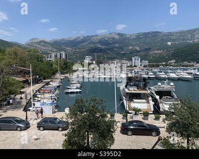 Port at Budva coastal city in Montenegro with boats and cars Stock Photo