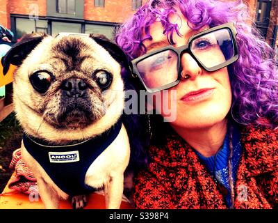 Funky urban woman with coloured hair and pet pug dog Stock Photo