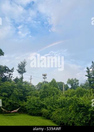 Rainbow over suburban yard. Stock Photo