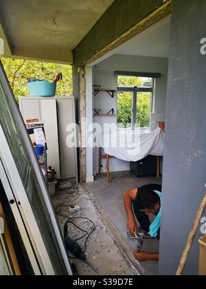 Construction workers installing a sliding window door. Stock Photo