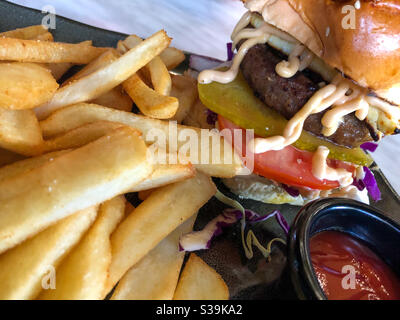 Hamburger and fries with tomato sauce on the side Stock Photo