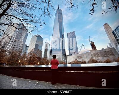 A woman enjoys a view of the Freedom Tower in New York City.