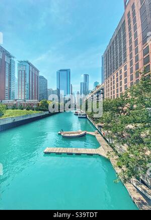 View of Chicago River and the riverwalk with boats docked on a beautiful sunny summer day in Chicago, Illinois Stock Photo