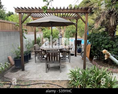 Backyard patio. Mission Teak Table n Chairs by Brown Jordan Stock Photo