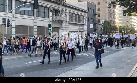 LOS ANGELES, CA, JUN 3, 2020: Black Lives Matter protestors with 'Defund the Police' placards march peaceful through Downtown Stock Photo