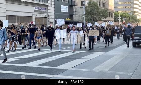 LOS ANGELES, CA, JUN 3, 2020: Black Lives Matter protestors march through Downtown with various signs aimed at ending racism Stock Photo