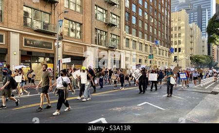 LOS ANGELES, CA, JUN 8, 2020: Black Lives Matter Protestors march through Downtown, past shops and restaurants closed due to Covid-19 pandemic Stock Photo