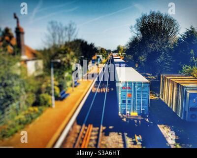 Freight train going through Trimley railway station on route to the port of Felixstowe, Suffolk, UK. Stock Photo