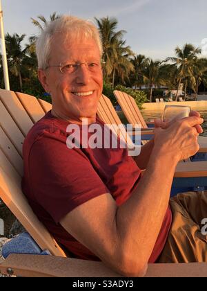 Senior man on vacation enjoying himself in the tropics. Stock Photo